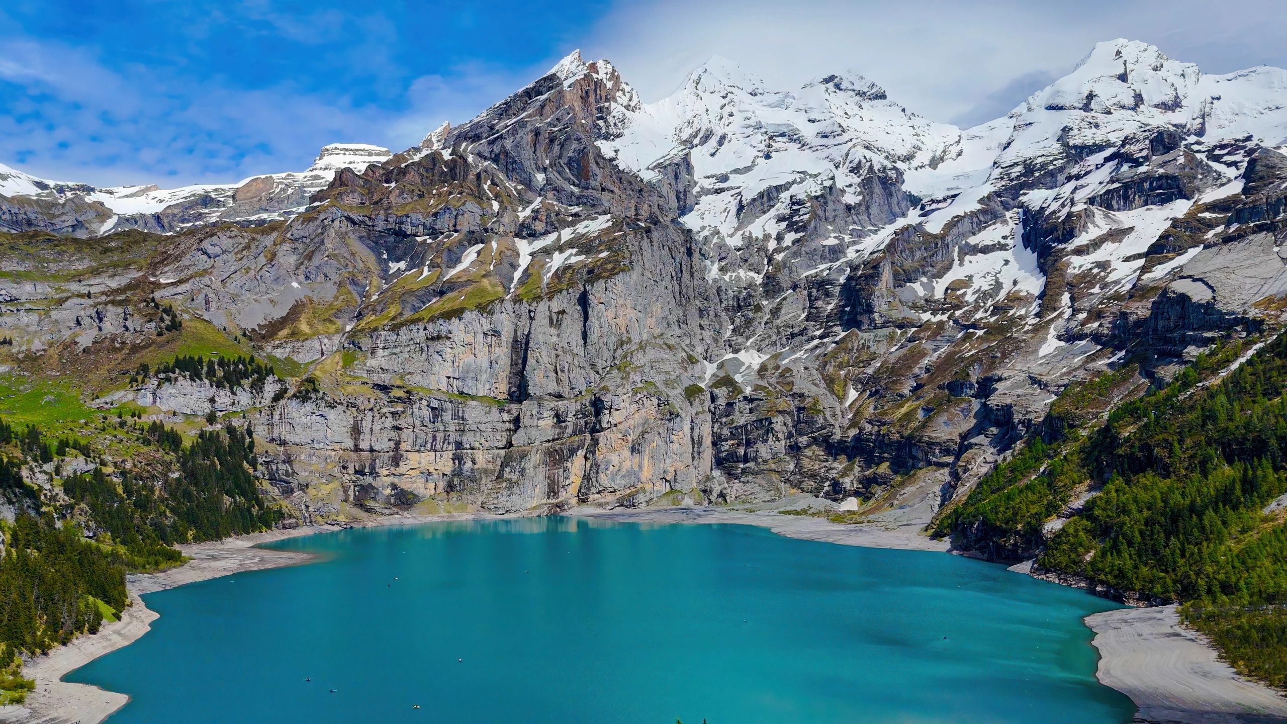 Turquoise alpine lake surrounded by dramatic mountain peaks