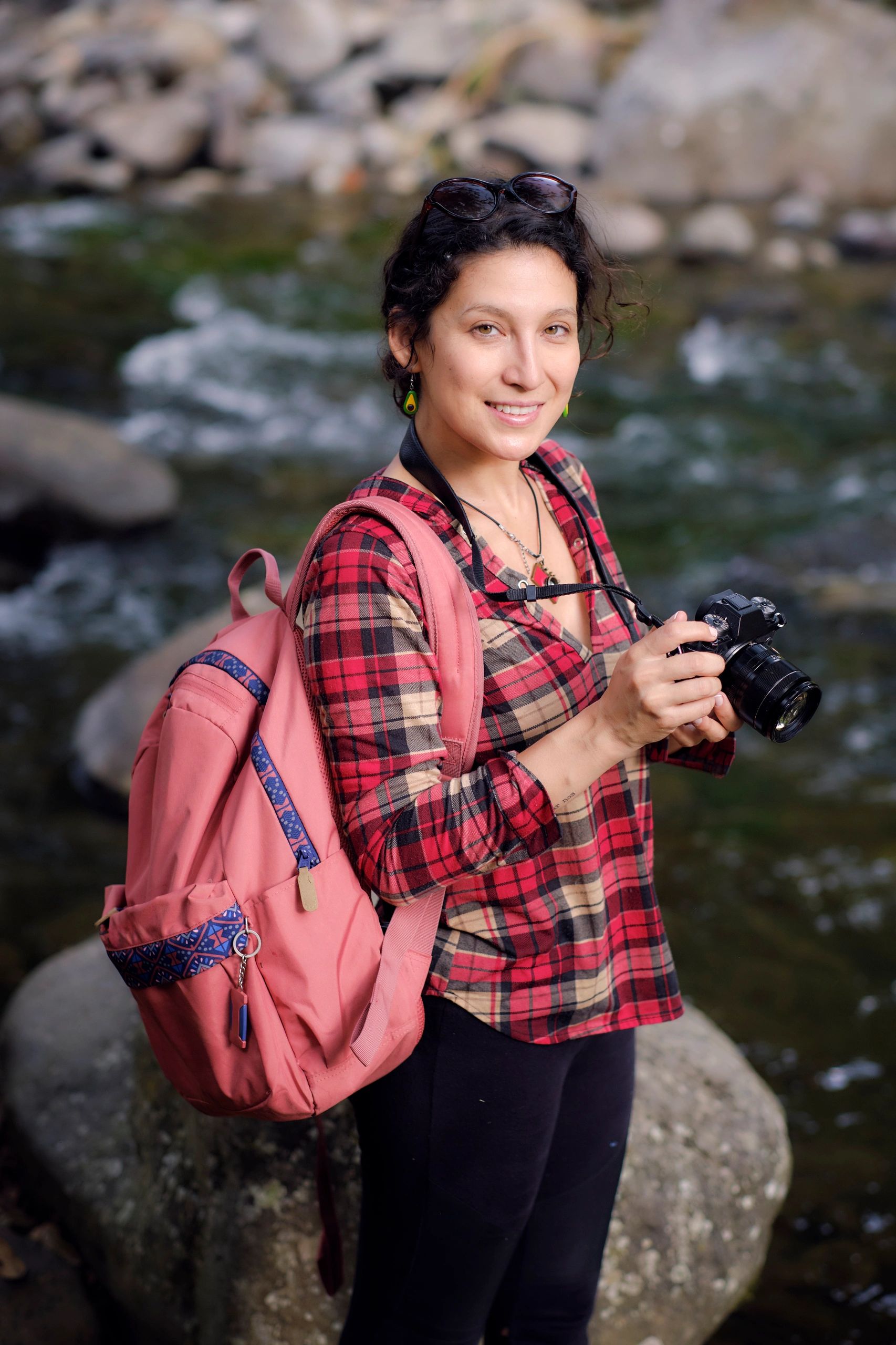 Woman photographer smiling while exploring nature